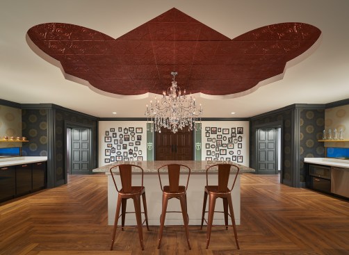 Trustify’s office environment transforms into an atypical workplace upon entry with front-door peepholes that peer into a crime scene rather than their front foyer. The curated frame wall features staff’s family, friends and pets. The pantry area offers adjacent perspectives into accent molded portals toward the contoured hallways and open office space.