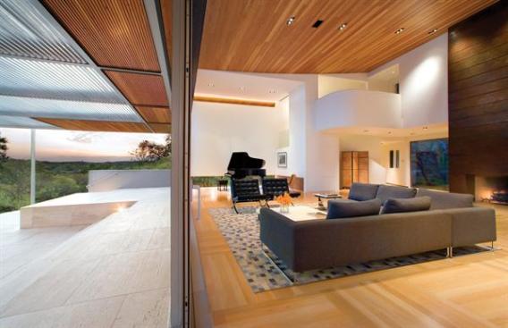 A reinvention of this 80s house turned the dining room into a gracious vestibule and the enlarged living room and terrace into a showcase for the pool and distant views.