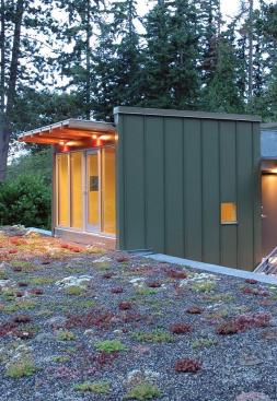 The budget-conscious building is constructed of polycarbonate, wood framing, and metal cladding and is topped with a homemade green roof of drought-tolerant succulents.