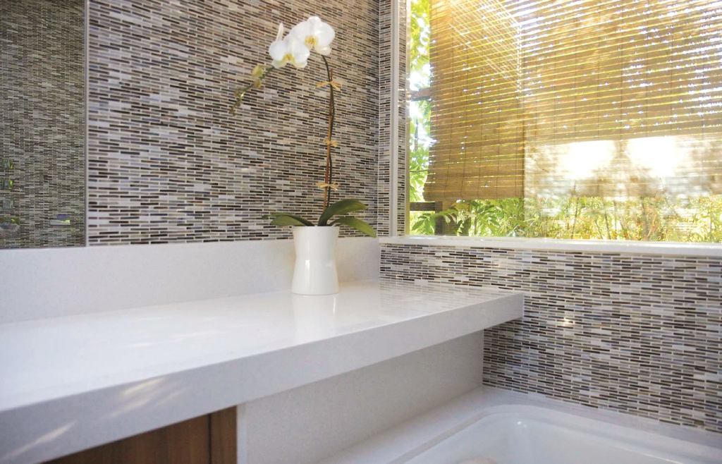 Fry Reglet Corp. produces a plentiful supply of channels and trim pieces that help solve transition problems. For this bath, Slant Studio used Fry reveals at the corners of the window and between the tile and mirror.