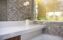 Fry Reglet Corp. produces a plentiful supply of channels and trim pieces that help solve transition problems. For this bath, Slant Studio used Fry reveals at the corners of the window and between the tile and mirror.