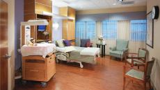 A labor and delivery room at Holmes Regional Medical Center in Melbourne, Fla. The room, designed by HKS, features family seating, an occasional table, and a computer station within the headwall cabinetry.