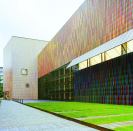 The brightly colored façade of the Brandhorst Museum in Munich is made up of squareprofile ceramic sticks mounted in front of a folded metal cladding. Before pursuing this design, the architects also considered metal fabric, perforated glass, and a perforated ceramic scrim, all of which were rejected for cost or aesthestic reasons.