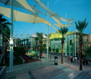 Fabric canopies standing approximately 50 feet tall stretch along the Shadow Walk plaza. Providing shade along the walkways during the day, at night the canopies are illuminated with 48W fluorescent uplights and 24W compact fluorescent downlights. Each canopy mast has three uplight and three downlight fixtures.