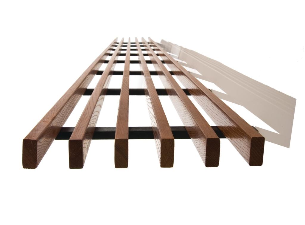 WoodWorks Grille is the newest addition to Armstrongs WoodWorks family of composite wood ceilings. The standard wood grille system mimics the look of solid wood and is available in two blade heights1-3/8" and 2-1/4"and four finishes, maple, light cherry, dark cherry, and walnut. The standard blade width is 5/8", and the ceiling system is offered in 1'-by-8' panels with either six or eight blades per foot. Custom options include blade height and width, finish, and number of blades per foot. Suitable for office, higher education, hospitality, and retail applications. When backed with 1" acoustical infill, WoodWorks Grille has a NRC of 0.9. The system installs on a standard Armstrong Prelude 15/16" grid. armstrong.com/woodworks