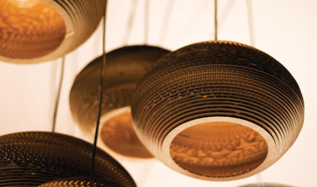 The playful corrugated cardboard Scrap Lights from Graypants are created from discarded cardboard boxes. They measure approximately 8" tall and have a diameter ranging from 12-1/2" to 16", depending on the size of the original box. The fixtures take a 40W bulb and are UL-listed. Two types of cords are available: one for hardwiring (in either 4' or 8' lengths) and one that can be plugged into a standard outlet (that comes in a 15' swag-set). Both cords are available in black or white. Scrap light shades are treated with No-Burn Class A fire retardant, which contains no VOCs. Each light is handmade and may vary in size or shape. graypants.com