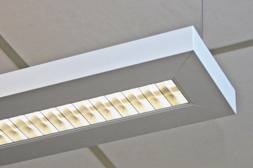 The new Series 52 direct-indirect pendant from Cooper Lighting brand Neo-Ray provides at least 90% efficiency, making it compliant with multiple energy codes. Available with single or double T5/T5HO or T8 lamps for design flexibility, the Series 52 fixture provides uniform illumination (60% up and 40% down). Its semi-specular parabolic louver features a ribbed clear overlay for precise optical control. Available in 3', 4', 6', and 8' lengths, the fixture can be hung by aircraft cable or can be stem or canopy mounted. The pendants extruded aluminum housing measures 1-3/4" wide by 7-1/4" long and ensures ultrastraight runs. Mitered ends provide a clean finish detail. neoray-lighting.com