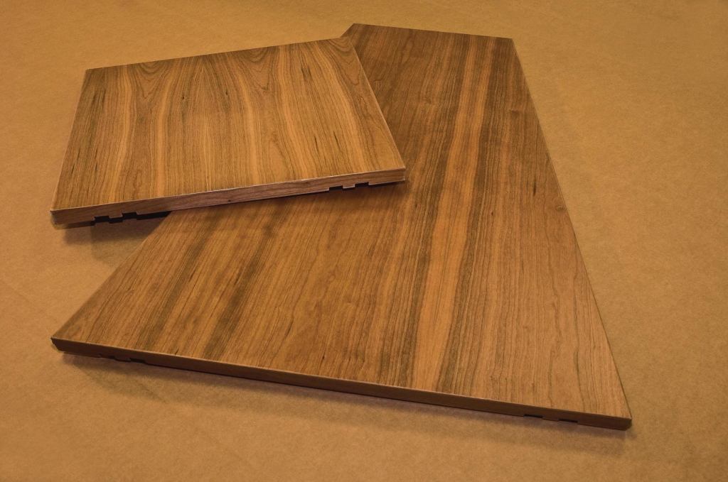 Veneer-wrapped aluminum panels allow greater design flexibility for ceiling and wall systems. These panels from Contact Industries range from 1' by 1' up to 4' by 8' and come in several shapes, including triangles, trapezoids, squares, and rectangles. The aluminum core products come from several manufacturers (including Hunter-Douglas and Simplex), and Contact Industries applies veneer to the face and each of the four edges. Components can be delivered prefinished with a variety of options, including fire-retardant coatings and custom tinting to match specified colors. Lineal veneered aluminum components up to 16' long with face widths ranging from 2" to 8" are also available. contactind.com