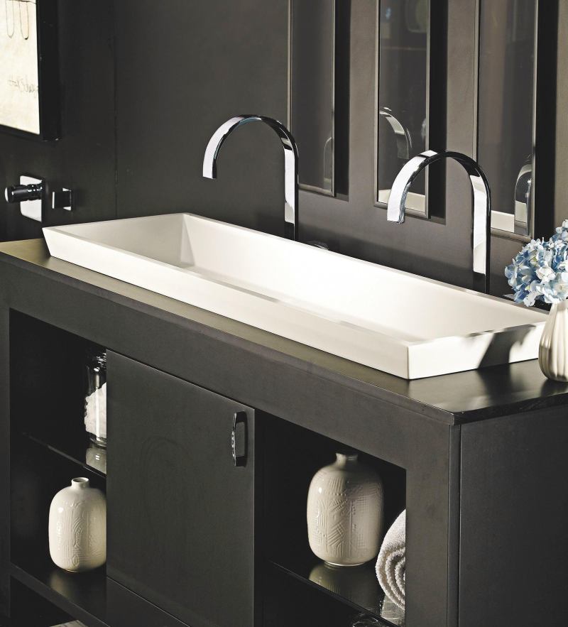 The Petra Double Sink from MTI Whirlpools has a solid-surface construction and a minimalist design. A complement to the Petra Tub, the sink looks and feels like natural stone. Its surface is nonporous, so it is naturally resistant to stains and can be cleaned with nonabrasive household cleaners. It is made of MTIs Engineered Solid-Surface material, a mixture of ground minerals and binding agents that are liquefied, poured, and hardened. The sink measures 47-1/2" long by 14" wide by 5-1/8" deep. It features one-piece construction and is available in white and biscuit in either a matte or gloss finish. Petra can be installed vessel-style on top of a vanity or ordered as a semi-recessed version. mtiwhirlpools.com