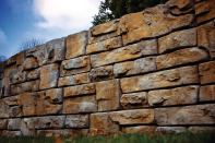 Redi-Rock Ledgestone, a new retaining wall face from Redi-Rock International, gives structural walls a rugged, natural look. The stones can be used to build tall gravity walls; users can achieve more height with reinforcement. Middle blocks weigh 2400 pounds, measure 46" by 41" by 18" high, and offer 5.75 square feet of face. redi-rock.com