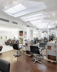 To create an inviting but understated space for the Bradley & Diegel Salon, Studio Luz Architects created a series of sculptural lightboxes to emulate existing skylights, and to infuse the long, linear space with more natural light.