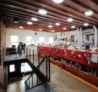 Forty-five, 14-inch-diameter tubular skylights with custom-designed socket assemblies that hold 23W 3500K CFL lamps, bring natural light into the second-floor main workspace at Focus Lighting's new office.