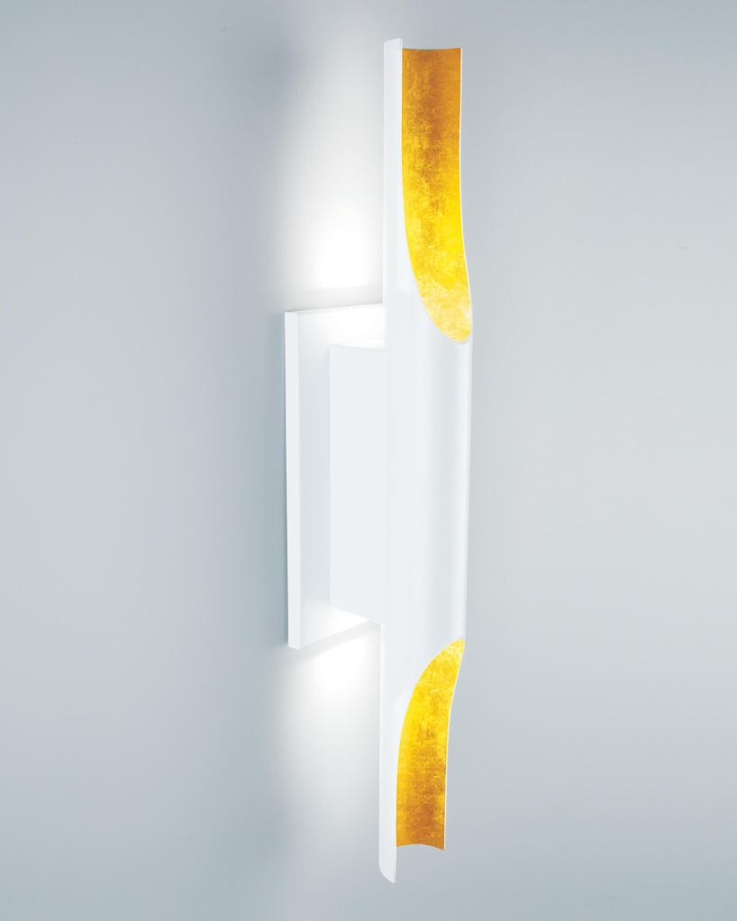 The LED Halfpipe Sconce from Boyd Lighting is inspired by the French Art Deco movement. The 22" tall sconce is manufactured by radius cutting a cylinder to create a scallop shape, in which LED lamps wash light up and down a wall. Additional LED lamps are installed in the backplate. Halfpipes LED lamps have 45 lumens-per-watt efficiency, a 70,000-hour life, a 3,100 K color temperature, and consume 9.6W of energy. The luminaire comes in multiple finishes, including white on white and black and white with an optional white or yellow gold leaf. The sconce can be mounted vertically or horizontally. boydlighting.com