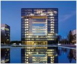 A nighttime exterior view of ThyssenKrupp Quarter, a corporate office building in Essen, Germany, was the winner of the 28th Annual GE Edison Award.