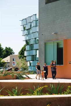 A family walks through the community plaza in front of the new Hollenbeck Police Station, in the Boyle Heights neighborhood of East Los Angeles.
