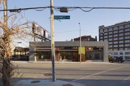 Sited in Kansas City?s burgeoning arts district, the Crossroads branch of Missouri Bank is located in a former auto-repair shop that dates back to the 1920s. Instead of tearing it down, the team from Helix turned it into a sleek new bank branch that caters to many of the artists and gallery owners that comprise the bank?s client base. Integrating art into these projects is a priority for Missouri Bank; bank CEO Grant Burcham purchased a pair of back-to-back billboards?that have towered over the building for many years?and has changed them into art-boards. Working with local group the Charlotte Street Foundation, Burcham and a team of employees choose from submissions by local artists. Winners are displayed on the art-boards and changed every three months.
