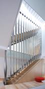 The design for the staircase is centered on folded stainless steel. Hung from a structural steel support on the top level of the townhouse, vertical folded pieces create a continuous screen that encloses the two above-grade flights of stairs. Tabs on the bent risers are fitted into slots on the vertical pieces, which created an easy setup for on-site construction and spot-welding.