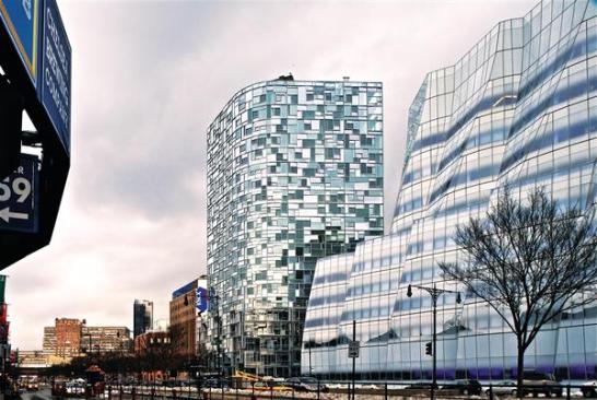 The matrix of frames created by the windows scatters reflections on the outside.