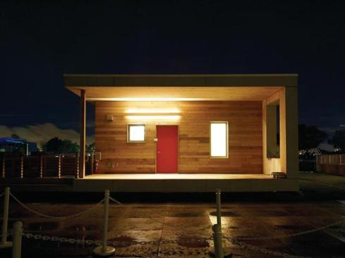 The house features a welcoming front porch, a private back porch with storage space, and an interior flex space that incorporates built-in shelving.