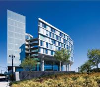 The Gateway's drum shape was derived from a series of site constraints - the trapezoidal parcel is bordered on all sides by existing roadways - and a desire to have a unique sculptural building on campus that reflects the creativity of the artists who live, work, and study there. The drum holds dormitory apartments. A nine-story rectangular tower on the northern face of the building houses studios for the art students.
