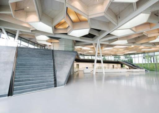 Each cell in the honeycomb ceiling of Barkow Leibinger's restaurant and event space is dedicated to a specific purpose, such as lighting or acoustics. Cells that incorportate luminaires are wired on different circuits, so that all the lights don't have to be turned on at once. Tubular speakers hang from some cells to distribute sound through the space during lectures, meetings, and concerts.