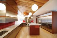 The kitchen's vertical-grain fir ceiling rises to the west wall.