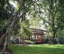 The structurally hung pavilion has a wind stabilizer, and mechanicals are embedded in the floor, with lines to underground compressors. A truck bed liner material protects the bottom.