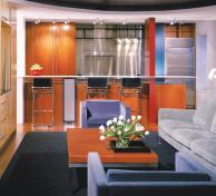A pair of pillars and a breakfast bar are all that separate the kitchen and living room, creating a strong relationship between the two spaces.