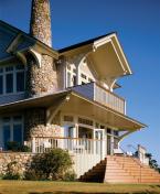 A stone wall encloses the home's base, keeping the elevated first floor from appearing too high off the ground. An east-facing, ipe-floored porch provides a space for entertaining groups and watching the sun rise.
