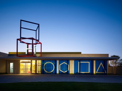 West elevation main entry at dusk
