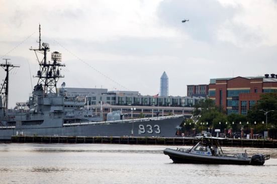 A police boat and helicopter patrol near the scene of a shooting at the Washington Navy Yard on Monday, Sept. 16, 2013, in Washington, D.C.