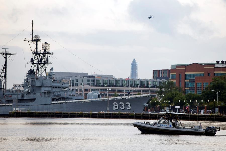 A police boat and helicopter patrol near the scene of a shooting at the Washington Navy Yard on Monday, Sept. 16, 2013, in Washington, D.C.