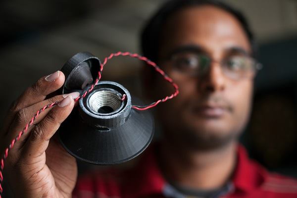 Cornell graduate engineering student Apoorva Kiran holds the 3D printed loudspeaker.