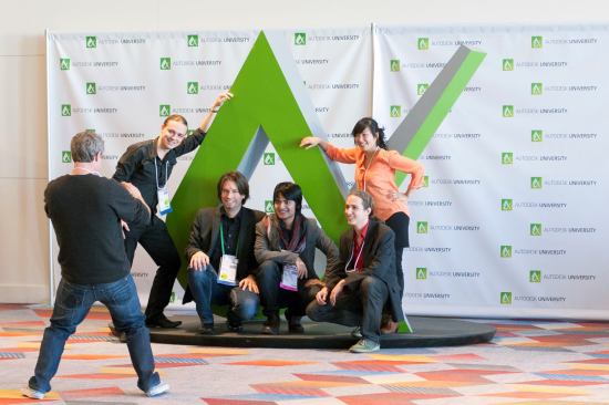 Attendees posed next to the Autodesk University logo sculpture.