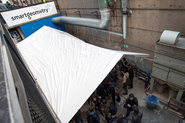 Smartgeometry participants and attendees mingle on the lower level of the Wates House at the Bartlett, UCL Faculty of the Built Environment in London. As the fabrication and 3D printing studio, the lower level of the facility saw a frenzy of actvity of a different kind in the days leading up to the April 19 exhibition.