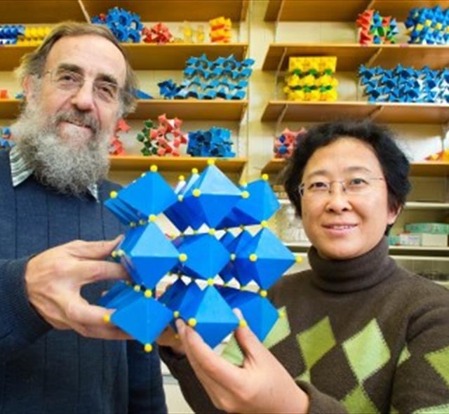 Researchers Ray Withers and Yun Liu with a model of a new dielectric material.