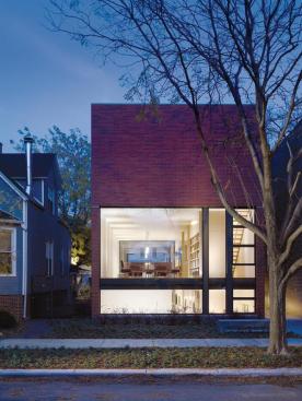 Fronted with a glass wall, the first-floor living space becomes an enclosed front porch.