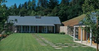 The lawn between the main building and the pool house serves as an outdoor room.