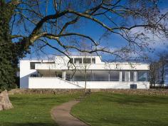 The+most+iconic+view+of+the+Villa+Tugendhat+is+from+the+garden.+The+massive%2c+nearly+10-by-20-foot+glass+panel+that+shields+the+living+room+can+recess+into+the+floor+below%e2%80%94though+originally+two+smaller+panes%2c+it+was+installed+as+a+single+panel+during+the+restoration.
