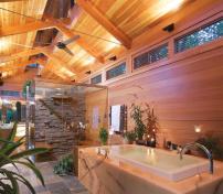 Clear coated Douglas fir on the inside and a red cedar exterior wrap the bath in a warm glow of natural wood, while tumbled slate tiles offer slipfree footing.