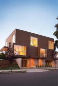 To capture natural light, this duplex stretches on an east west axis and elevates its main living spaces above street level.