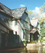 A muddled colonial and borderline teardown candidate provided the raw material for this extensive Shingle style remodel. Despite the thoroughness of the transformation, however, a surprising amount of original structure remains.