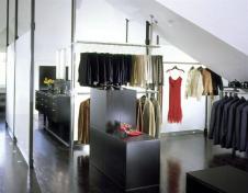 Black granite, laminated glass, and oak floors stained black create elegant, ethereal spaces that float beneath the chaotic roofscape of this Victorian attic.