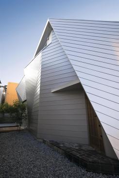 Galvanized steel-faced sandwich panels wrap the building in a modern skin.