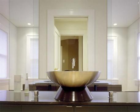 A painted MDF base raises the vessel lav off the lower-than-standard countertop height and up to a more comfortable position.