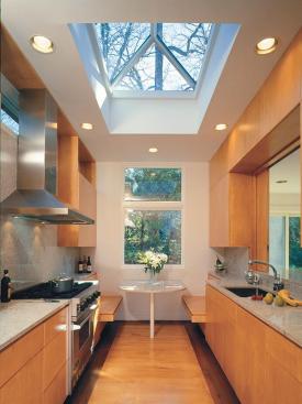 Seamless granite and stainless steel surfaces reflect the abundant light, helping the kitchen feel bigger and even brighter.