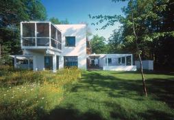The outdoor rooms are framed with white stained wood and screened with 2x2 slats.