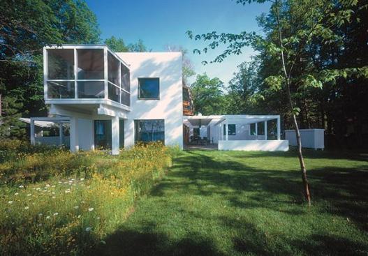 The outdoor rooms are framed with white stained wood and screened with 2x2 slats.