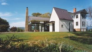 The new parts of the project a glass pavilion, a tall clapboard portion, and an entry hall and circulation space all pay homage to the existing farmhouse through their forms and materials.
