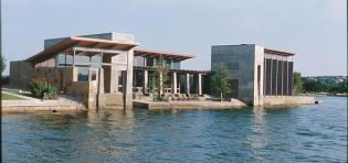 A covered porch connects the houses living spaces and slips down to the water. At the end is the master suite,which is rotated slightly to give it more privacy and its own view. Kitchen storage is part of the architecture  Cabinets become a well defined